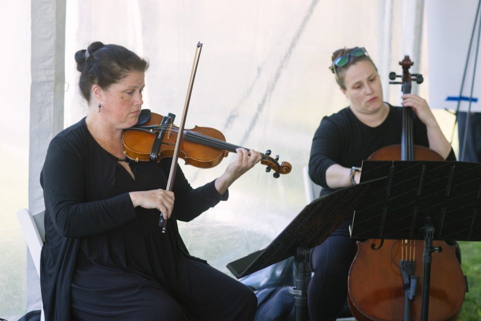 Violin and cello duo performing at the ChemPartner Boston anniversary celebration
