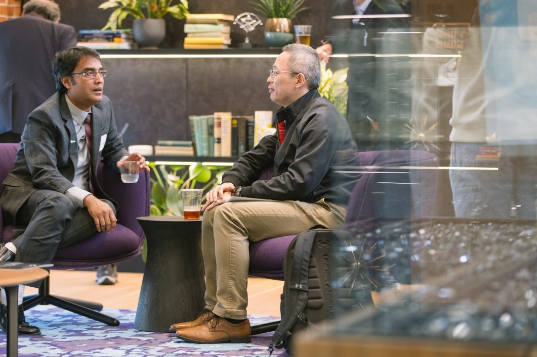 Guests in conversation with ChemPartner scientists at a Discovery Lounge