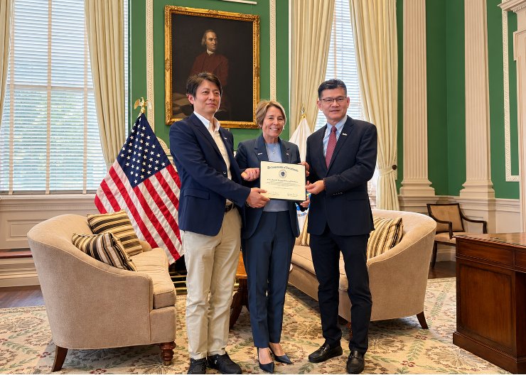 Governor Maura Healey presenting a Commonwealth of Massachusetts citation to ChemPartner leadership